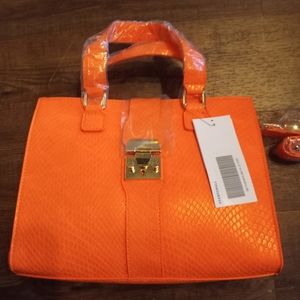 FWP.  Sold.Justfab beautiful orange satchel with lock.  NWT